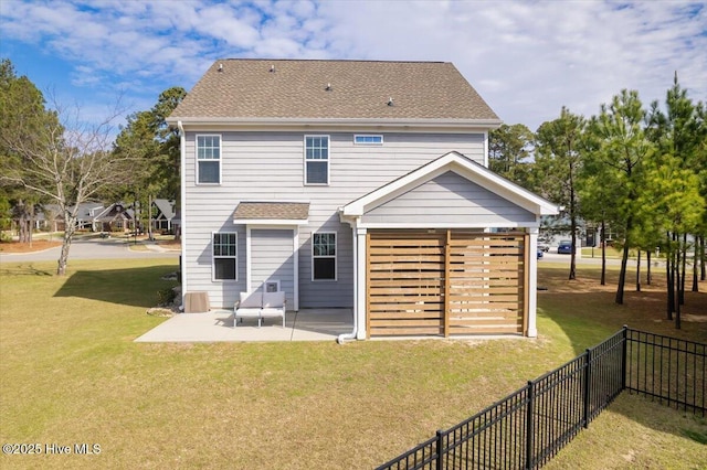 rear view of house with a lawn and a patio