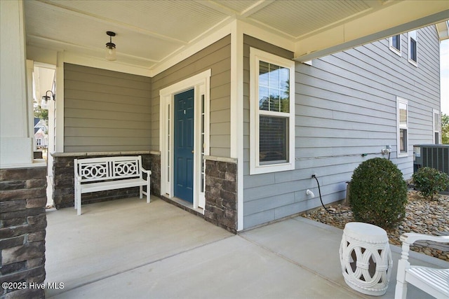 doorway to property featuring a porch and central air condition unit