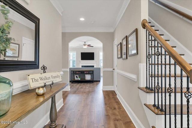 corridor featuring wood-type flooring and ornamental molding