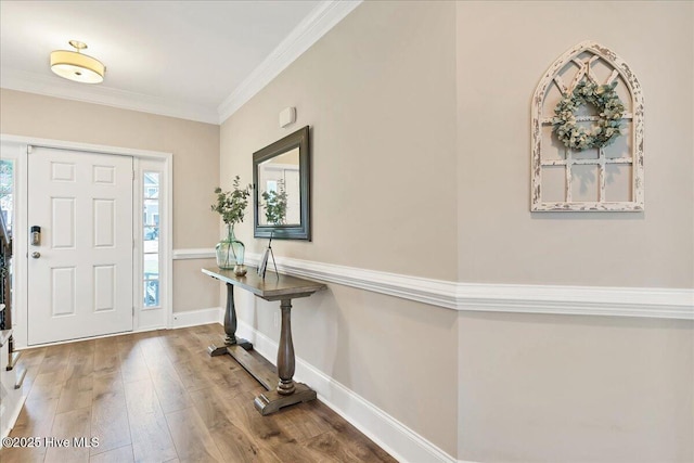 foyer featuring wood-type flooring and ornamental molding