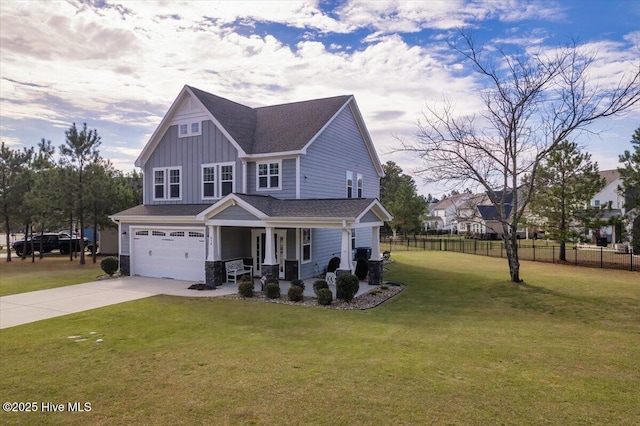 view of front of property featuring a garage, a front yard, and covered porch