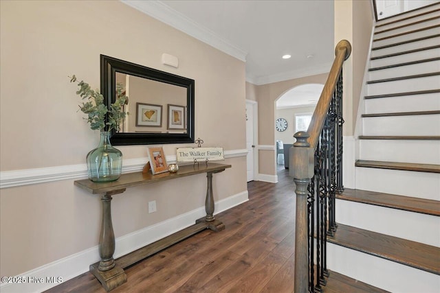 entrance foyer with dark wood-type flooring and crown molding