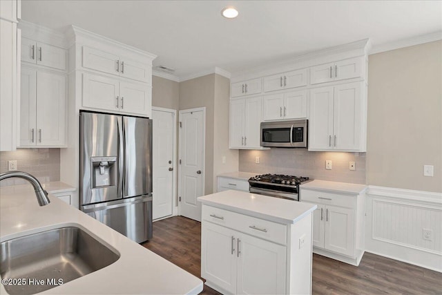 kitchen featuring appliances with stainless steel finishes, white cabinetry, and sink