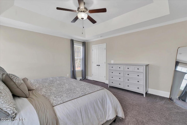 carpeted bedroom featuring ceiling fan, a tray ceiling, and ornamental molding