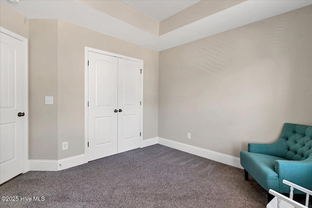 unfurnished room featuring dark colored carpet