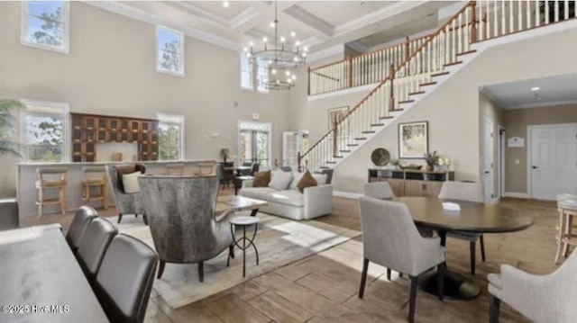 interior space with coffered ceiling, a towering ceiling, a chandelier, crown molding, and beam ceiling