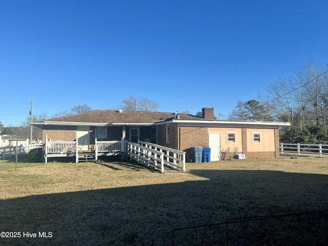 back of property featuring a yard