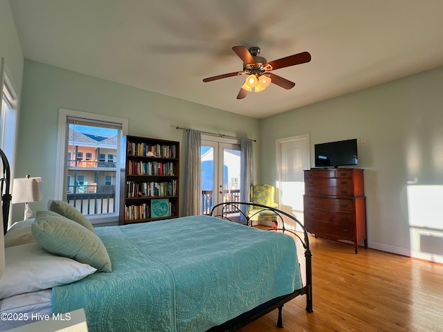 bedroom with ceiling fan, light wood-type flooring, and french doors