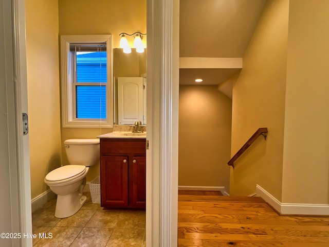 bathroom with toilet and vanity