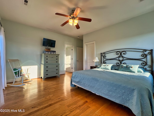 bedroom with ceiling fan and hardwood / wood-style flooring