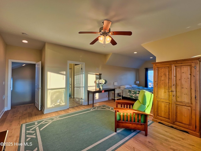 interior space with ceiling fan, vaulted ceiling, and light hardwood / wood-style flooring