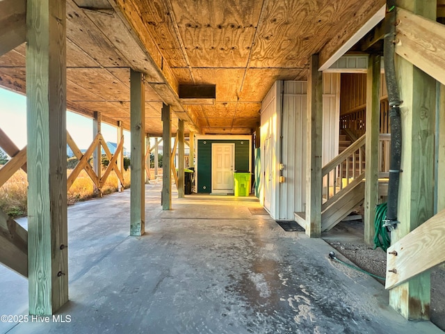 miscellaneous room with wooden ceiling and concrete flooring