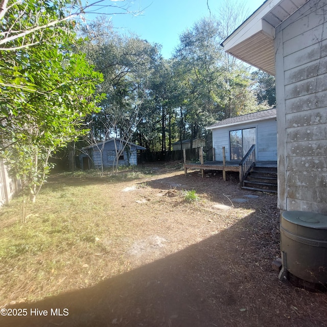 view of yard featuring a wooden deck