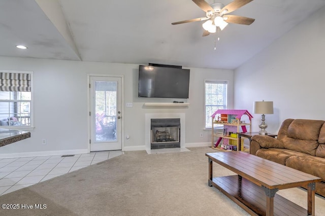 living room featuring light carpet, ceiling fan, and lofted ceiling