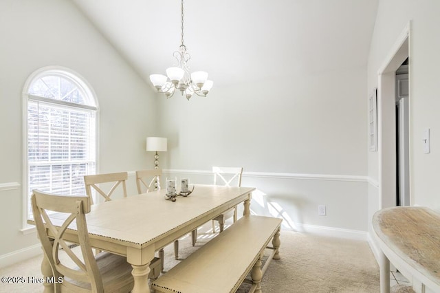 dining space featuring high vaulted ceiling, light colored carpet, and a notable chandelier