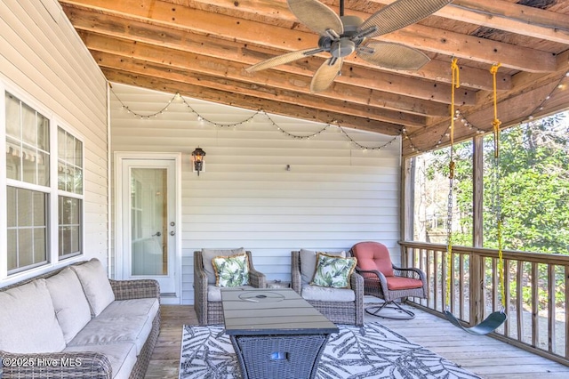 wooden terrace featuring an outdoor living space and ceiling fan