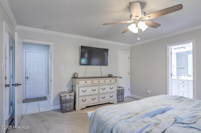 bedroom featuring ceiling fan, crown molding, light carpet, and ensuite bath