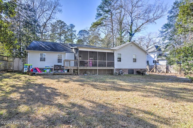 rear view of house with a sunroom and a lawn