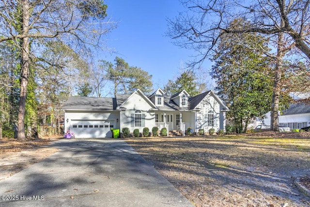 cape cod house featuring a porch and a garage