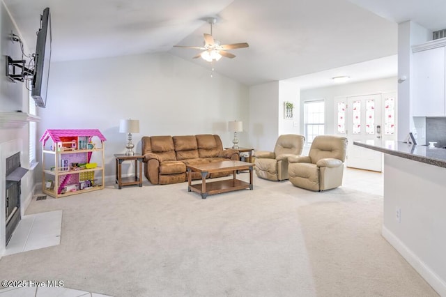 living room with ceiling fan, carpet floors, and lofted ceiling