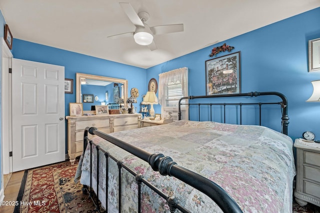 bedroom with ceiling fan and hardwood / wood-style flooring