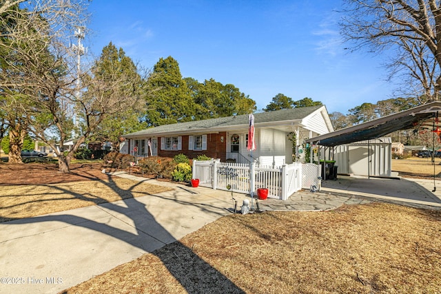 ranch-style house with a shed and a carport