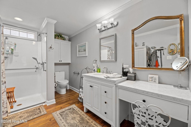 bathroom featuring ornamental molding, vanity, a shower, hardwood / wood-style flooring, and toilet