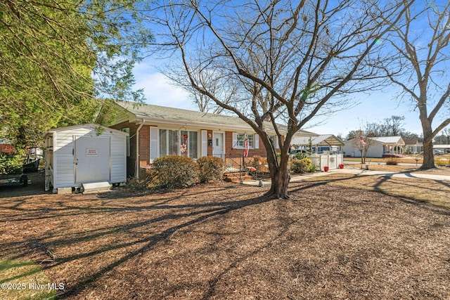 view of front of home with a storage shed