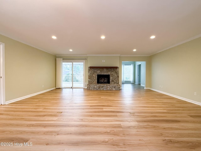 unfurnished living room featuring a fireplace, light wood-type flooring, and crown molding