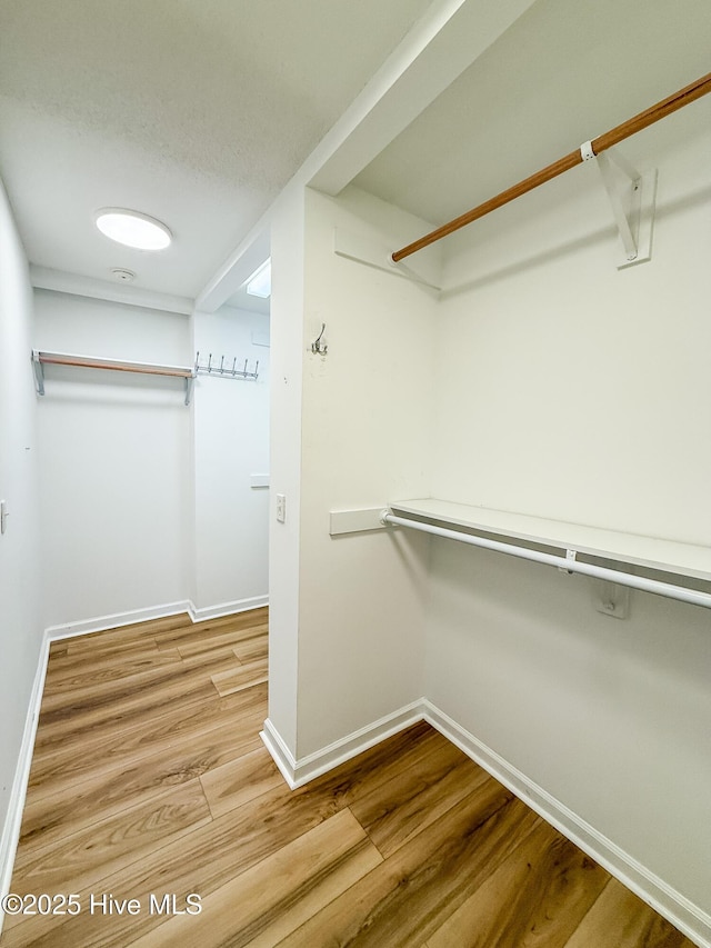 spacious closet featuring hardwood / wood-style flooring