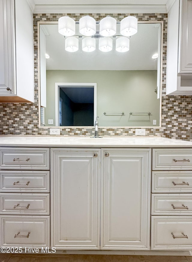 bathroom featuring vanity and tasteful backsplash