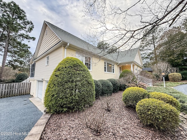 view of side of home featuring a garage