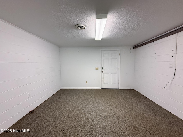 basement featuring carpet and a textured ceiling