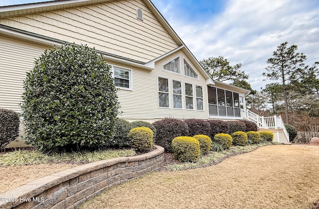 view of home's exterior with a sunroom