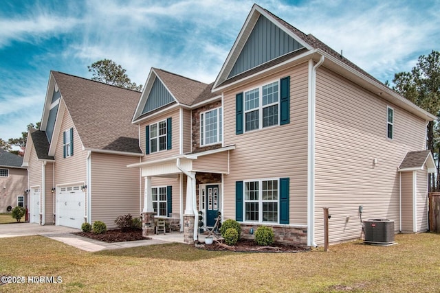 view of front of property featuring central AC, a front lawn, and a garage