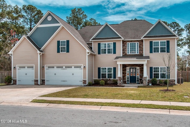 craftsman house with a front lawn and a garage