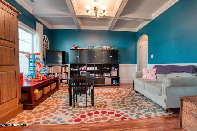 living room featuring coffered ceiling, crown molding, hardwood / wood-style flooring, an inviting chandelier, and beamed ceiling