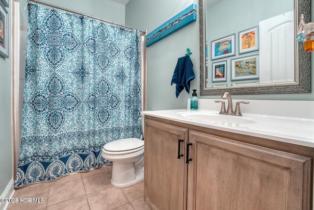 bathroom with tile patterned flooring, vanity, curtained shower, and toilet