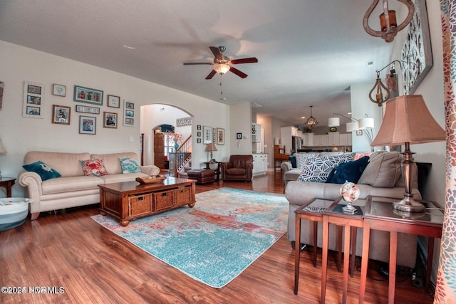 living room with dark hardwood / wood-style floors and ceiling fan