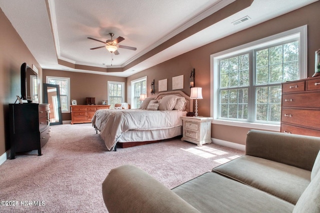 bedroom featuring a tray ceiling, crown molding, ceiling fan, and light colored carpet