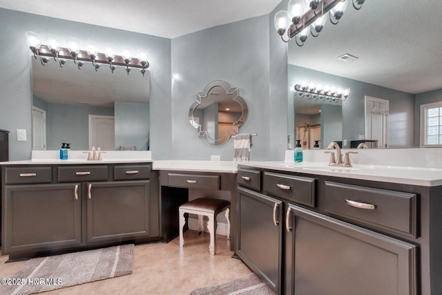 bathroom with tile patterned flooring and vanity