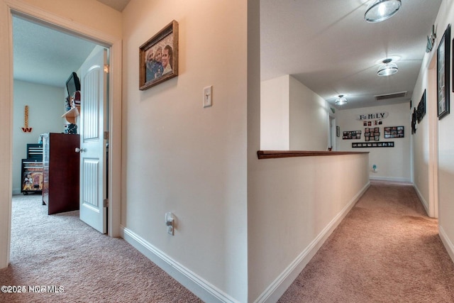 corridor featuring light colored carpet