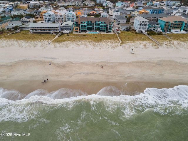 drone / aerial view featuring a water view and a beach view