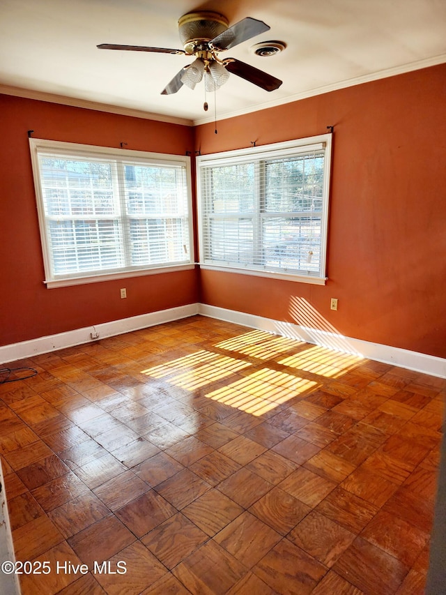 spare room featuring ceiling fan and crown molding