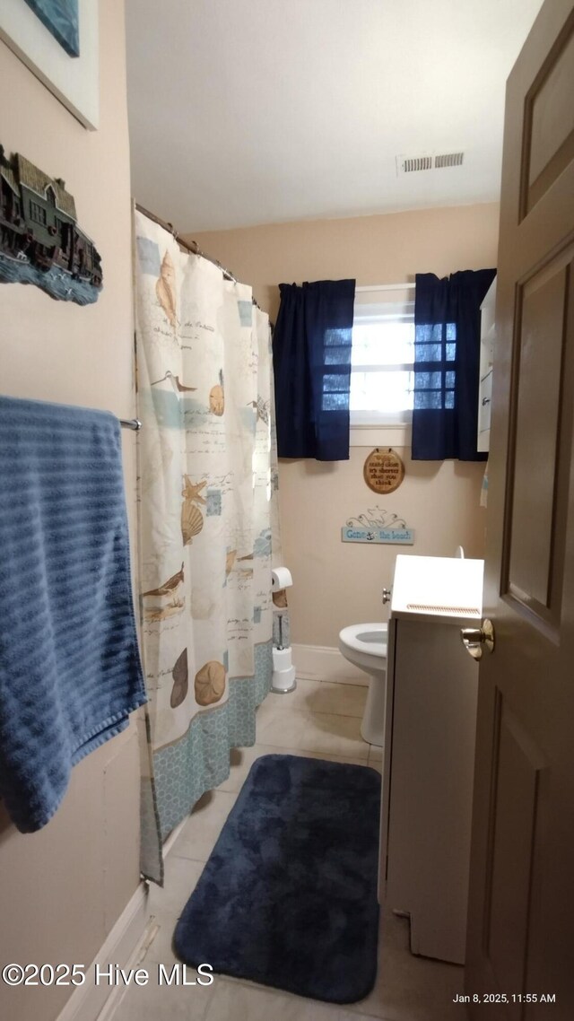 bathroom with tile patterned floors and vanity