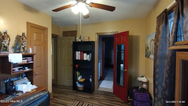 interior space with ceiling fan and dark hardwood / wood-style flooring