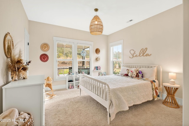 bedroom with multiple windows and carpet