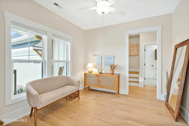 sitting room with ceiling fan and light hardwood / wood-style flooring