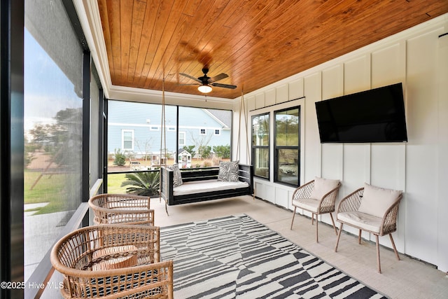 sunroom with wooden ceiling and ceiling fan