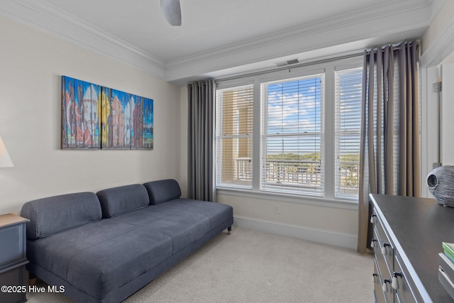 living room featuring light colored carpet, ceiling fan, and crown molding